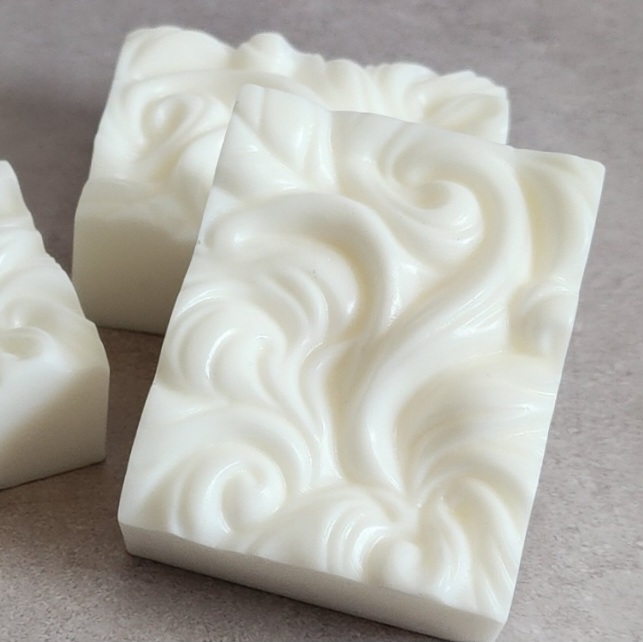 White textured swirly soap on top of a gray countertop.