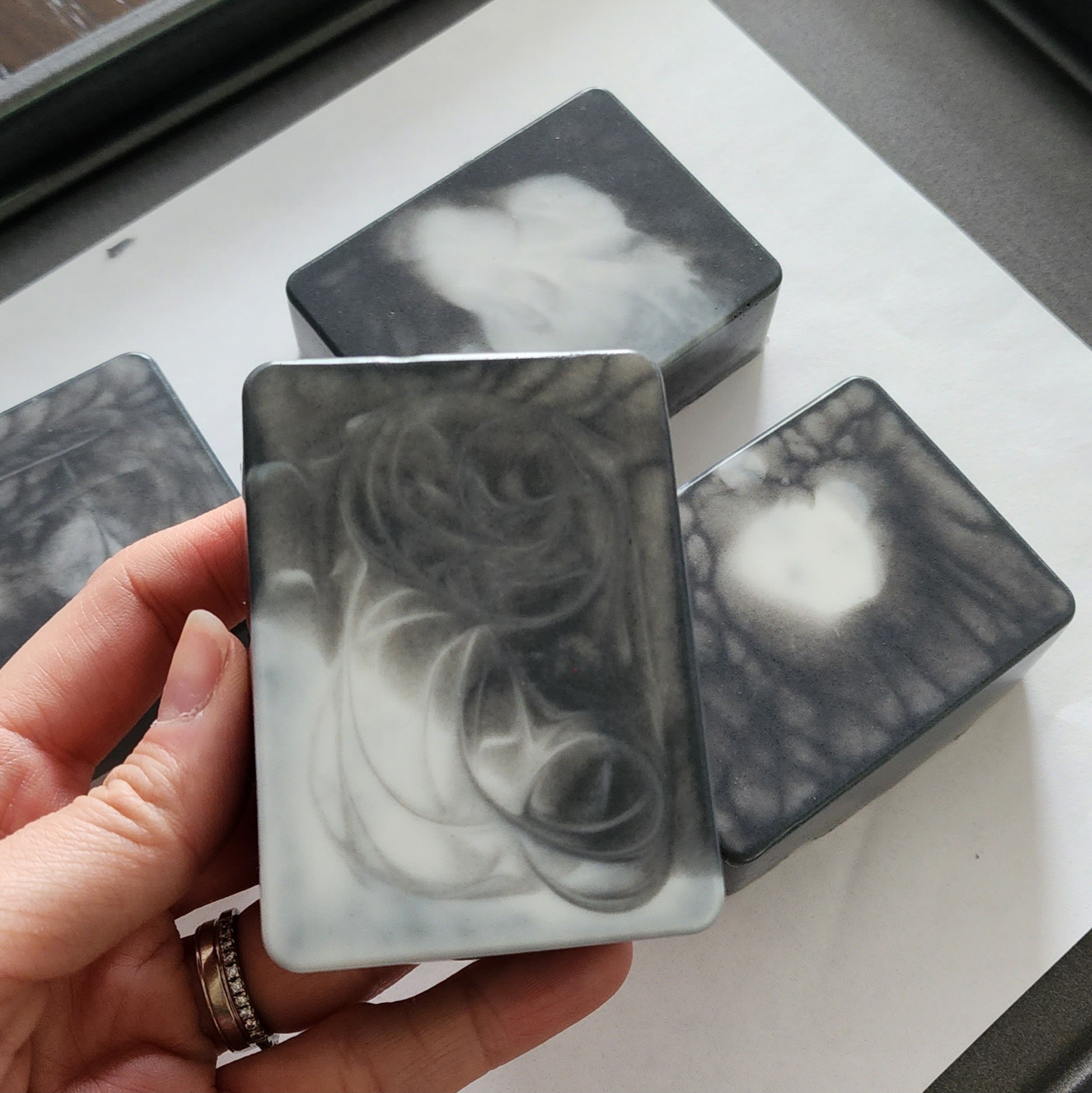 Activated charcoal bars of soap laid out on a sheet pan.